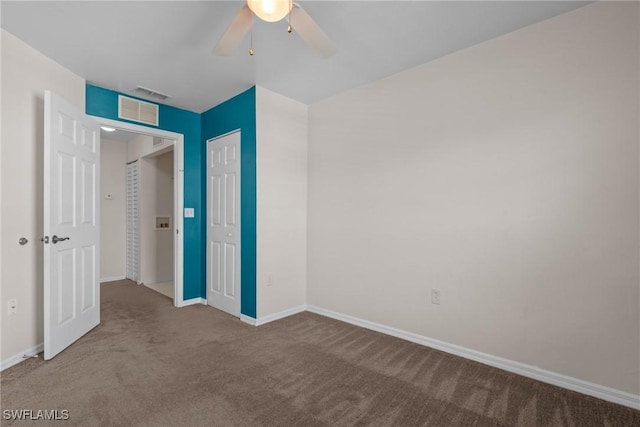 unfurnished bedroom featuring ceiling fan, a closet, and carpet flooring