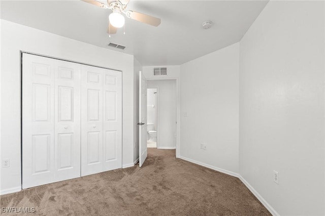 unfurnished bedroom with ceiling fan, a closet, and carpet floors