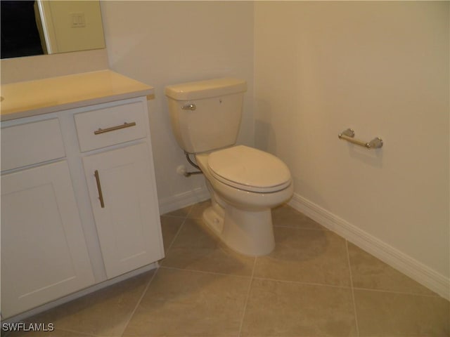 bathroom featuring toilet, vanity, and tile patterned floors