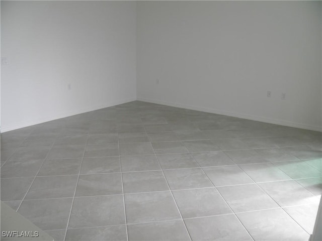 spare room with light tile patterned flooring