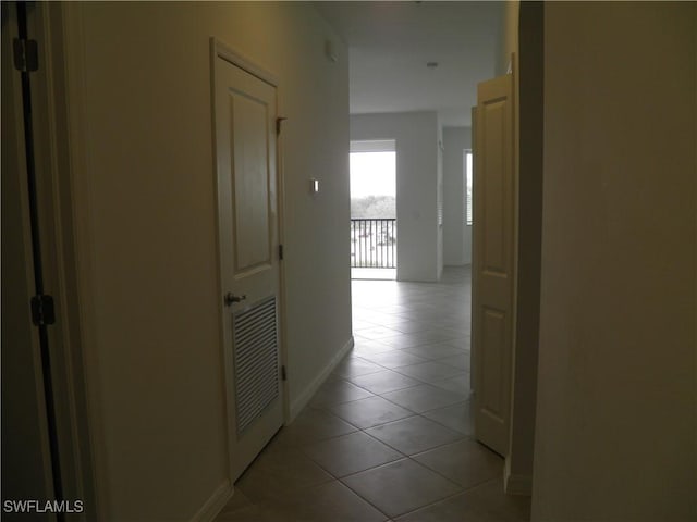 corridor with light tile patterned floors