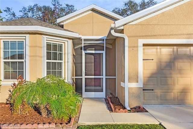 view of exterior entry featuring a garage