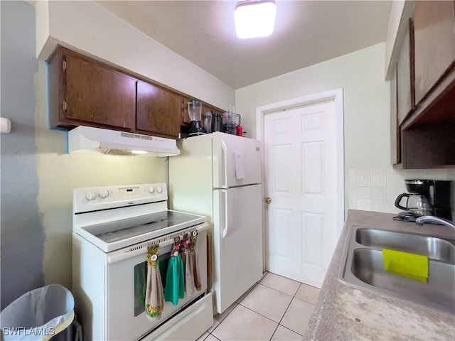 kitchen featuring sink, white appliances, and light tile patterned floors