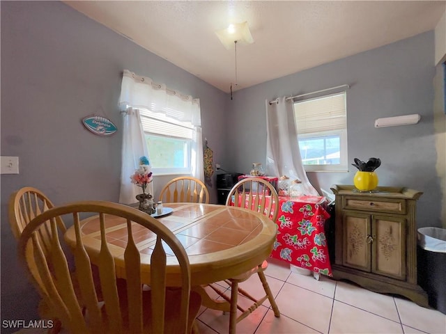 dining area with light tile patterned floors