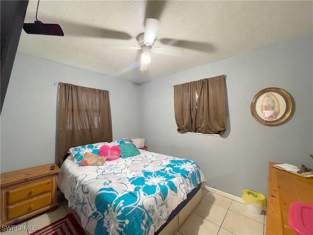 tiled bedroom featuring a textured ceiling and ceiling fan