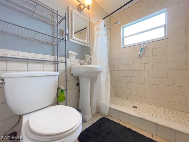 bathroom with toilet, a shower with shower curtain, and tile patterned floors