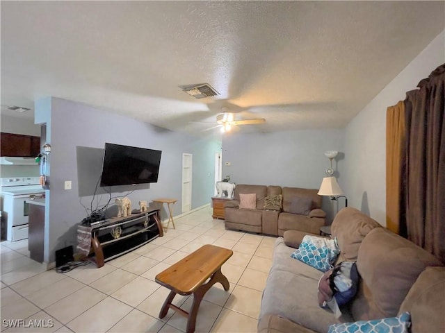 tiled living room with a textured ceiling and ceiling fan