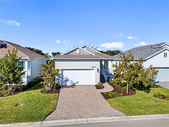 view of front of property featuring a garage and a front yard