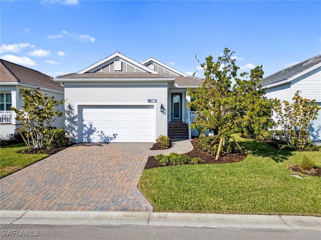 view of front of home featuring a garage and a front lawn