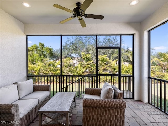 sunroom / solarium featuring ceiling fan