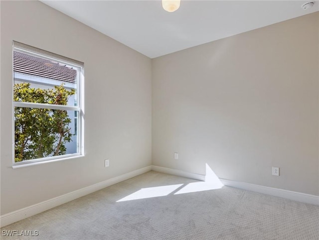 spare room featuring light colored carpet