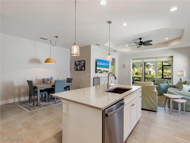 kitchen with pendant lighting, sink, white cabinets, a center island with sink, and stainless steel dishwasher