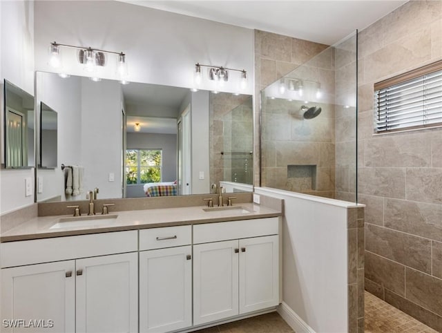 bathroom with vanity and a tile shower