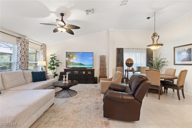 living room featuring ornamental molding, lofted ceiling, light tile patterned floors, and ceiling fan