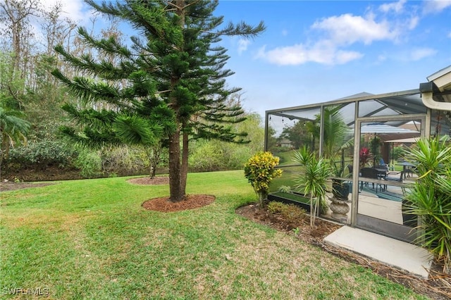 view of yard featuring glass enclosure