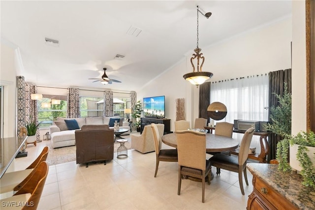 tiled dining area featuring crown molding, vaulted ceiling, and ceiling fan