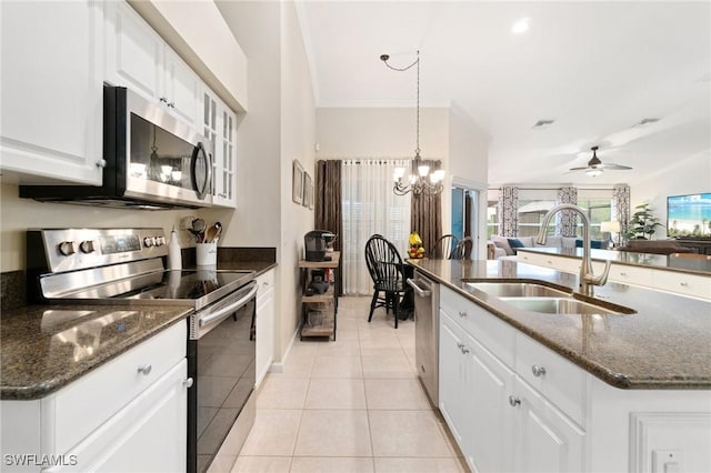 kitchen featuring sink, light tile patterned floors, appliances with stainless steel finishes, a kitchen island with sink, and white cabinets