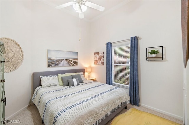 bedroom with crown molding, ceiling fan, and light colored carpet