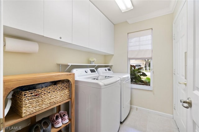 laundry area featuring independent washer and dryer, cabinets, and ornamental molding