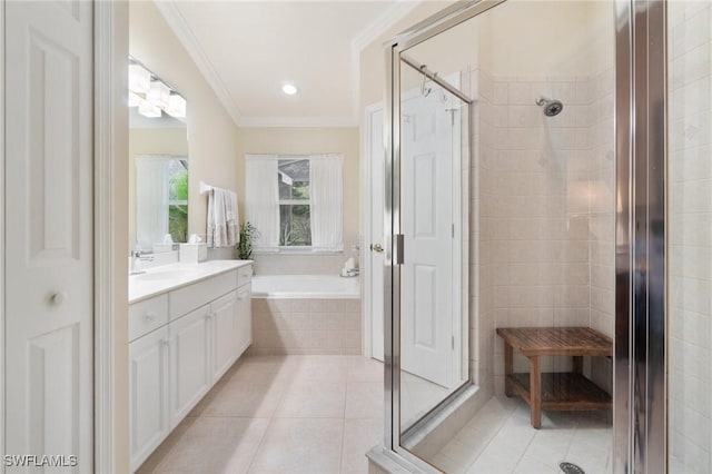 bathroom featuring plus walk in shower, ornamental molding, tile patterned floors, and vanity