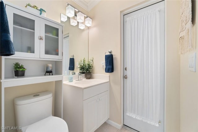 bathroom with vanity, crown molding, and toilet