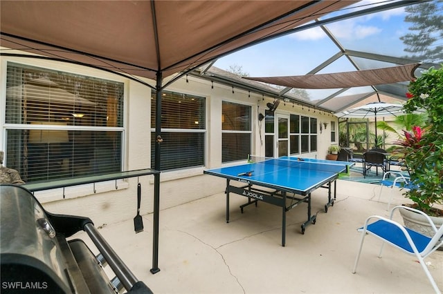 view of patio / terrace featuring glass enclosure