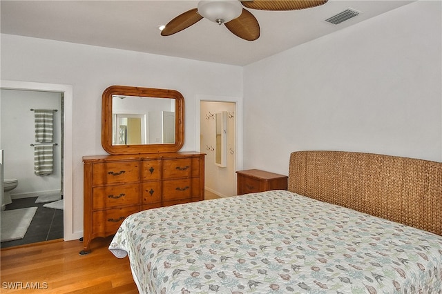 bedroom with ceiling fan, light hardwood / wood-style floors, and ensuite bathroom