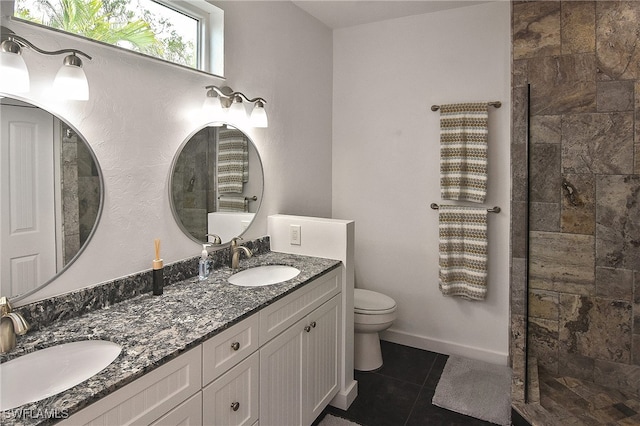 bathroom featuring toilet, tile patterned flooring, a shower, and vanity