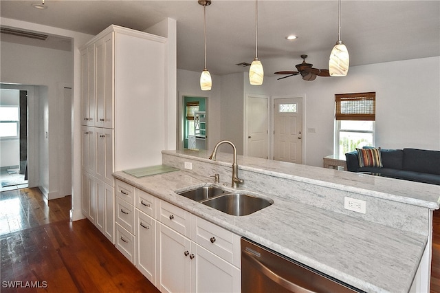 kitchen with decorative light fixtures, ceiling fan, sink, and white cabinetry