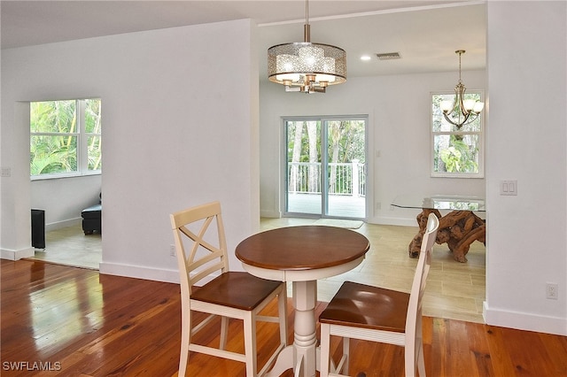 dining area with a chandelier and hardwood / wood-style floors