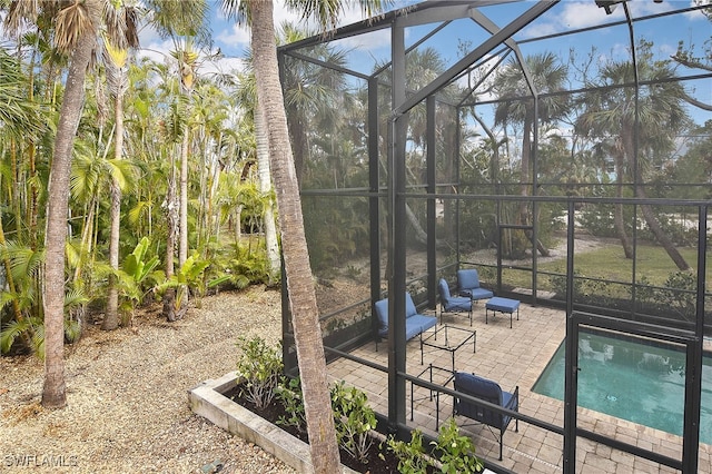 view of pool with a lanai and a patio