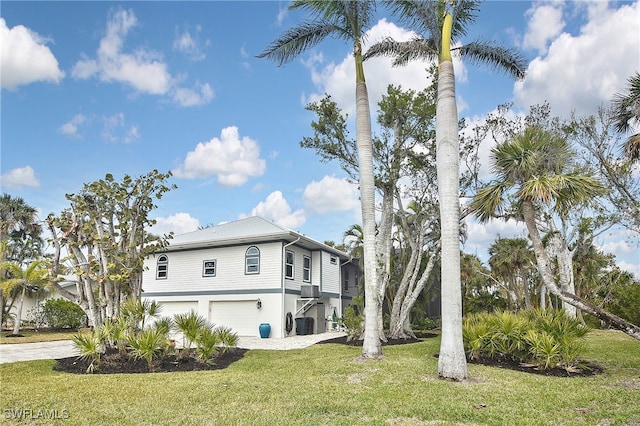 view of home's exterior with a garage and a yard