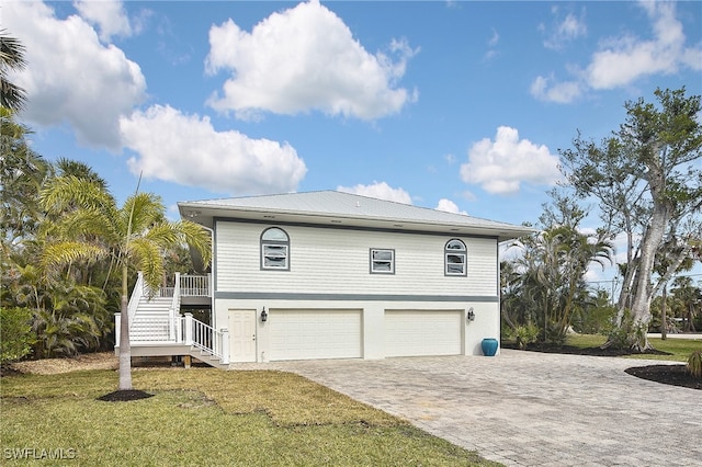 view of property exterior featuring a garage and a yard