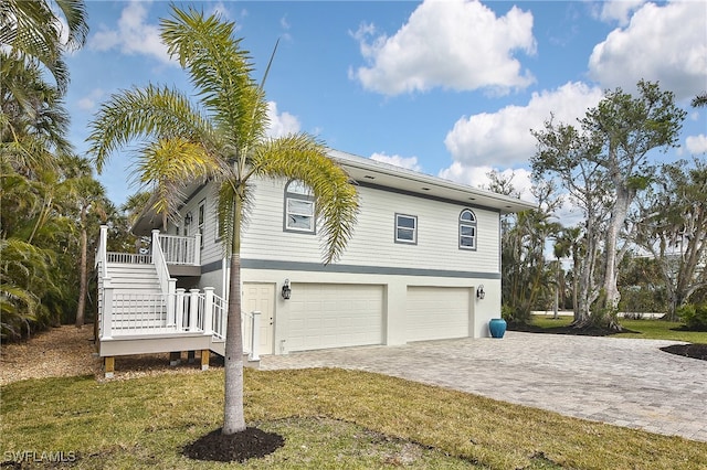 view of side of home with a garage and a yard