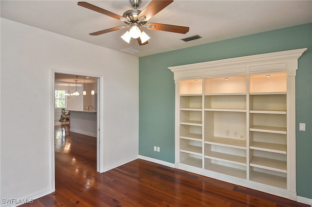 interior space with ceiling fan with notable chandelier and dark hardwood / wood-style floors