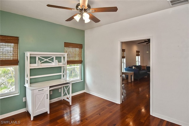 office featuring ceiling fan, dark hardwood / wood-style flooring, and built in desk