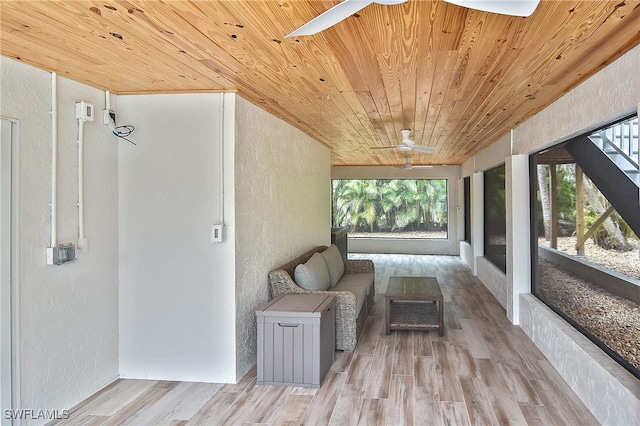 unfurnished sunroom featuring ceiling fan and wood ceiling