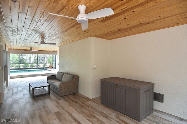 sitting room with a swimming pool, wood ceiling, light hardwood / wood-style flooring, and ceiling fan