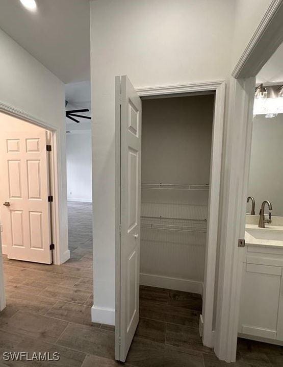 bathroom featuring ceiling fan and vanity