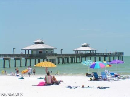 exterior space with a gazebo, a beach view, and a water view