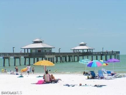 exterior space featuring a gazebo, a water view, and a view of the beach