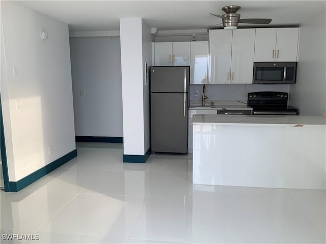 kitchen with sink, white cabinetry, ceiling fan, light tile patterned floors, and appliances with stainless steel finishes