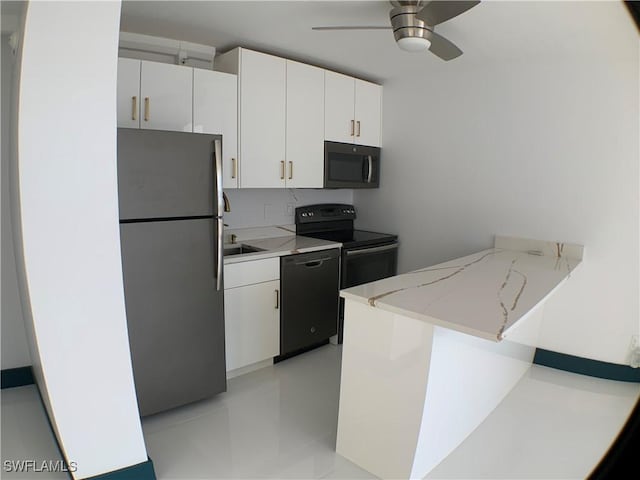 kitchen with kitchen peninsula, light stone countertops, black appliances, white cabinetry, and ceiling fan