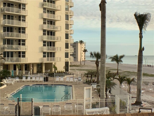 view of pool featuring a patio area and a water view