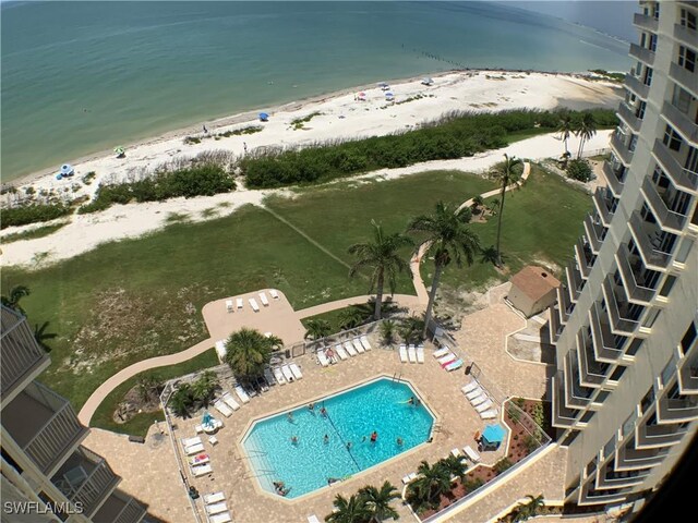 birds eye view of property with a view of the beach and a water view