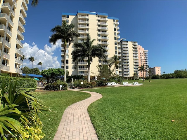 view of property's community with a lawn