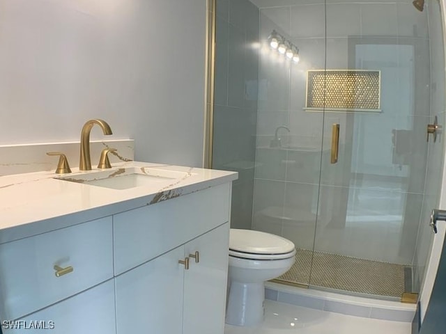 bathroom featuring tile patterned flooring, vanity, an enclosed shower, and toilet