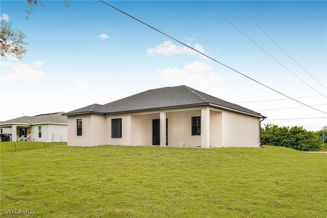 rear view of property featuring a yard