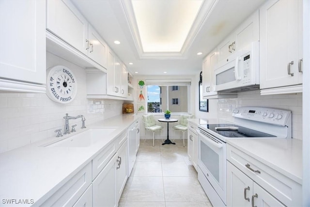 kitchen featuring tasteful backsplash, white appliances, sink, and white cabinets