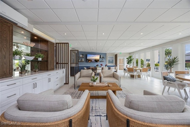 tiled living room featuring a drop ceiling